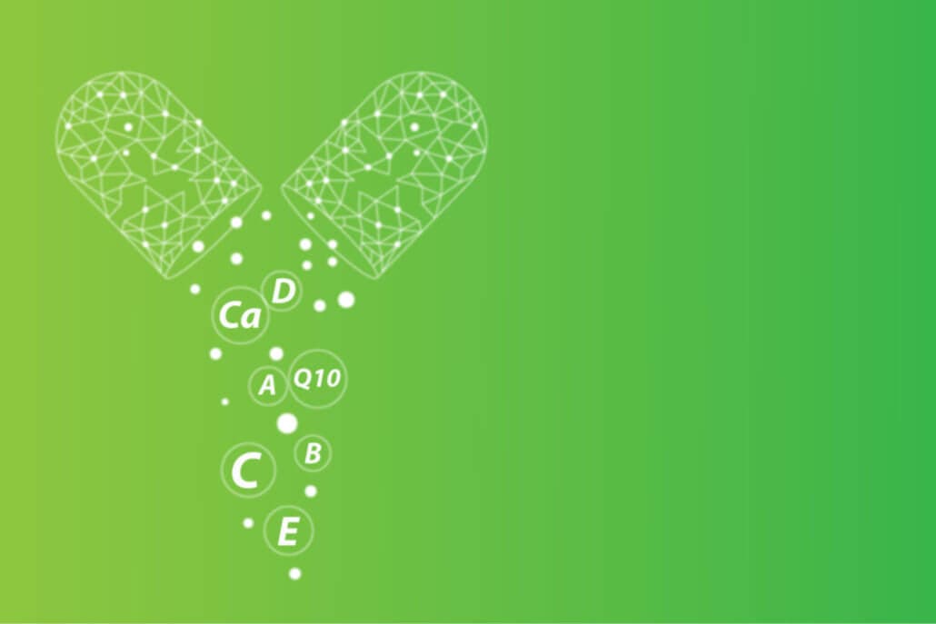 Woman taking supplements on a table with green background